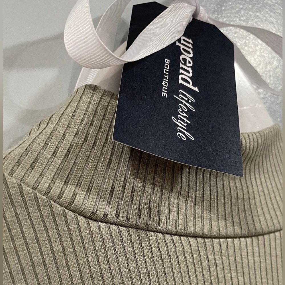 Chic layering. Sage green mock neck bodysuit. Thong back snap closure.